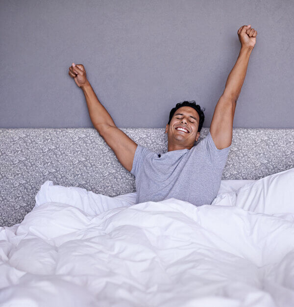 Person waking up refreshed after a restful night's sleep using proven strategies from GoodNightSpell.com